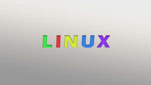 灰色漸變背景上的彩虹色 Linux 文字。 — 7680x4320 壁紙