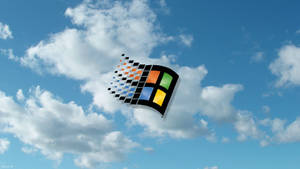 Microsoft Windows 標誌在藍天白雲中像素化 — Windows 98 壁紙