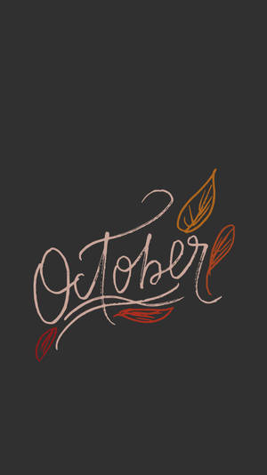 「October」以流暢的字體書寫，暖色調的落葉在深色背景上飄落。 — 十月 壁紙