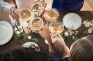 Friends toasting with champagne glasses at a decorated dinner table. — 醉意朦朧 壁紙