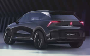 黑色雷諾 Scenic SUV 配備發光的紅色尾燈，在現代工作室環境中。 — 雷諾 壁紙
