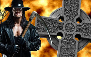 摔角手 The Undertaker 手持鐮刀，站在凱爾特十字架旁，背景火熱。 — 送葬者 壁紙