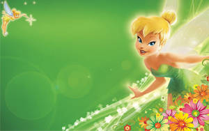 Tinker Bell 在發光的綠色背景下飛翔於色彩繽紛的花朵之間。 — 奇妙仙子 動圖 壁紙