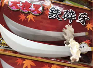 兩把白色動漫風格劍，帶有火焰手柄，放在紅色楓葉主題盒子上。 — 動漫惡魔 壁紙