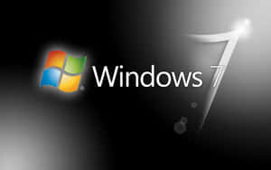 Windows 7 操作系統標誌，帶有彩色視窗圖示和發光數字 7。 — 深色窗戶 壁紙
