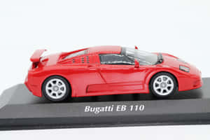 紅色Bugatti EB 110模型車在黑色底座上展示，帶有白色文字。 — Surface Pro 壁紙