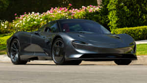 啞光灰色McLaren Speedtail停放在盛開的粉紅色和白色花朵旁邊。 — 白色法拉利 壁紙