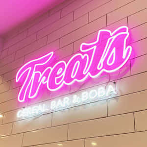 瓷磚牆上為 Treats Cereal Bar & Boba 設置的粉紅色霓虹燈招牌。 — 霓虹燈 壁紙