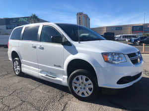白色道奇Grand Caravan小型貨車停在賭場附近陽光普照的城市停車場。 — 4:3 壁紙