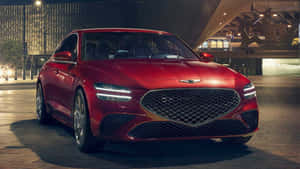 紅色豪華轎車夜間停放在現代城市廣場。 — 創世紀 壁紙