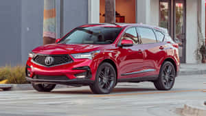 紅色Acura SUV停泊在靠近現代建築和棕櫚樹的城市街道上。 — Acura 壁紙