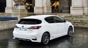 白色Lexus CT200h夜間停在濕滑路面上石柱下方。 — 凌志 壁紙