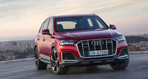 紅色Audi Q7 SUV停泊在日落時分的城市觀景點。 — 奧迪 GIF 壁紙