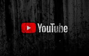 深色紋理背景上帶有飛濺效果的 YouTube 標誌。 — YouTube 標誌 壁紙