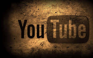 YouTube 標誌在粗糙混凝土牆上，帶有聚光燈效果。 — YouTube 標誌 壁紙