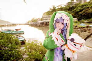 穿著綠色恐龍服裝的Cosplayer在河邊拿著絨毛玩具。 — 日式 壁紙
