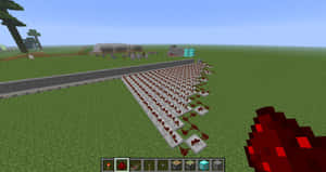 Minecraft玩家在草地上大型紅石火炬網格附近手持紅石火炬。 — 我的世界 鑽石 壁紙