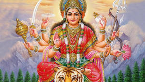 多臂印度教女神手持武器和花朵，騎著老虎。 — Maa Durga 壁紙