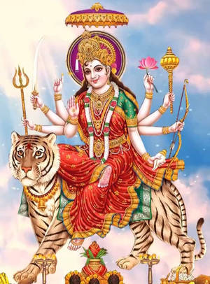印度教女神杜爾迦多臂騎虎，手持武器和蓮花。 — Maa Durga 壁紙