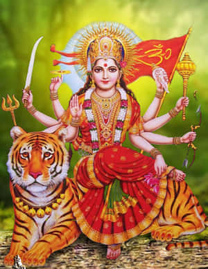 多臂的印度教女神杜爾迦騎著老虎，手持武器和旗幟。 — Maa Durga 壁紙