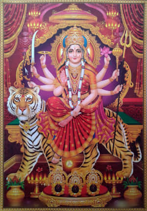 多臂印度教女神騎著老虎，手持武器和蓮花，在寺廟環境中。 — Maa Durga 壁紙