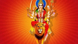 多臂印度教女神騎著獅子，背景是光芒四射的橙色。 — Maa Durga 壁紙