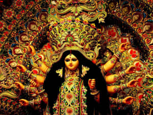 一位多臂印度教女神，身著華麗珠寶和鮮豔服飾。 — Maa Durga 壁紙