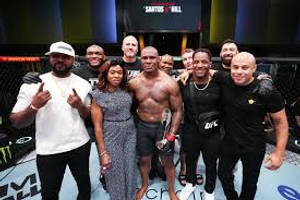 UFC拳手與團隊在八角籠內慶祝勝利。 — 惡夢佛萊迪 壁紙