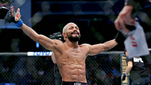 UFC拳手在八角籠內舉起雙臂慶祝勝利。 — 終極格鬥冠軍賽 壁紙