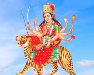 多臂印度教女神騎著老虎，手持武器和象徵物。 — Maa Durga 壁紙