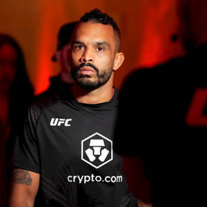 UFC拳手在室內活動中穿著crypto.com襯衫，處於紅燈下 — 運動 壁紙