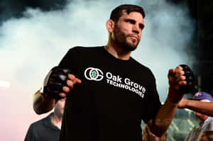 運動員戴著黑色手套，穿著Oak Grove Technologies襯衫，在煙霧繚繞的競技場中。 — 運動 壁紙