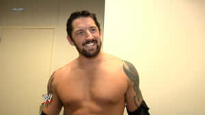 有刺青的WWE摔角手微笑赤裸上身站在後台 — WWE GIF 壁紙