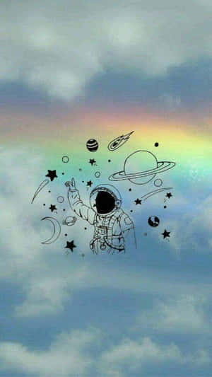 一位太空人在多雲的天空中指向一道彩虹，周圍有漂浮的行星和恆星。 — 彩虹美學 壁紙