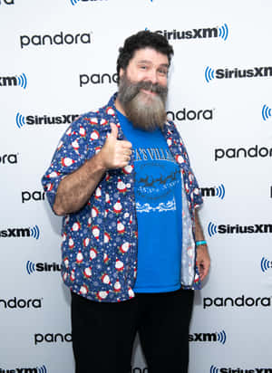 留鬍鬚男子穿聖誕襯衫在SiriusXM活動豎起大拇指。 — WWE GIF 壁紙
