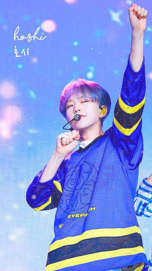 K-pop表演者在色彩繽紛的舞台上舉拳唱歌 — 黃仁燁 壁紙
