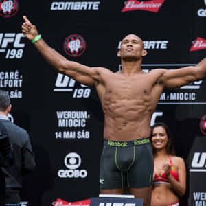 UFC拳手在稱重活動中高舉雙臂慶祝勝利。 — 終極格鬥冠軍賽 壁紙