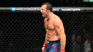 MMA拳手在籠中張開嘴巴、握緊拳頭慶祝勝利。 — 終極格鬥冠軍賽 壁紙
