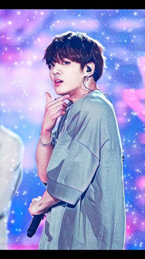 K-pop 表演者在星光下舞台上握著麥克風。 — JDM風格 壁紙