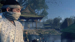 一位身穿長袍的男子站在寺廟前 — 對馬戰鬼 壁紙