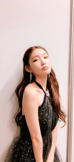 身穿閃亮黑色連衣裙的年輕女士靠著牆。 — 尚氣 壁紙