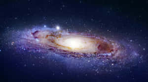 一個螺旋星系，在深空中擁有發光的旋臂和無數恆星。 — 星際效應 壁紙