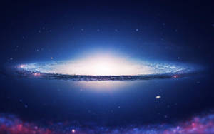 一個發光的螺旋星系，在黑暗的星空背景下呈現藍色和白色色調。 — 藍色銀河 壁紙