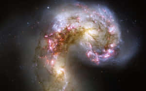 一個充滿活力的螺旋星系，在深空中擁有發光的星團和宇宙塵埃。 — 宇宙美學 壁紙