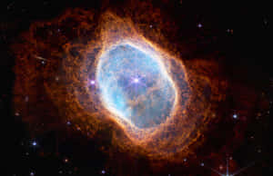 一個發光的宇宙星雲，藍色中心，橙色觸手，周圍環繞著星星。 — 宇宙 壁紙