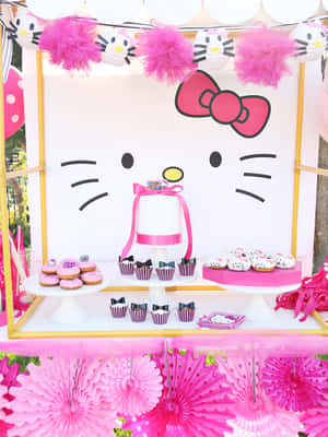 Hello Kitty主題派對甜點桌，配有粉紅色裝飾和美食。 — Kindle 壁紙