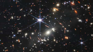 深空視野，有發光的星系和明亮的恆星。 — 環球影城 壁紙
