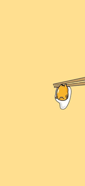 一個卡通貓臉在筷子夾著的餃子中，背景是黃色。 — 卡通 壁紙
