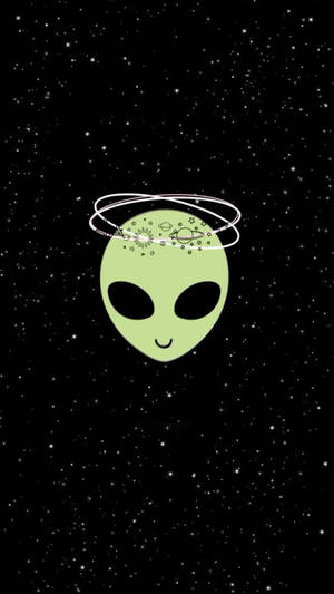 一個微笑的綠色外星人，帶著繞行的行星，在星光閃爍的太空背景前。 — 酷 壁紙