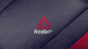 Reebok 標誌位於有紋理的深藍色布料上，帶有紅色對角線條紋。 — Lexus 標誌 壁紙